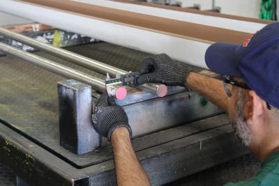 Quality team measuring metal thickness